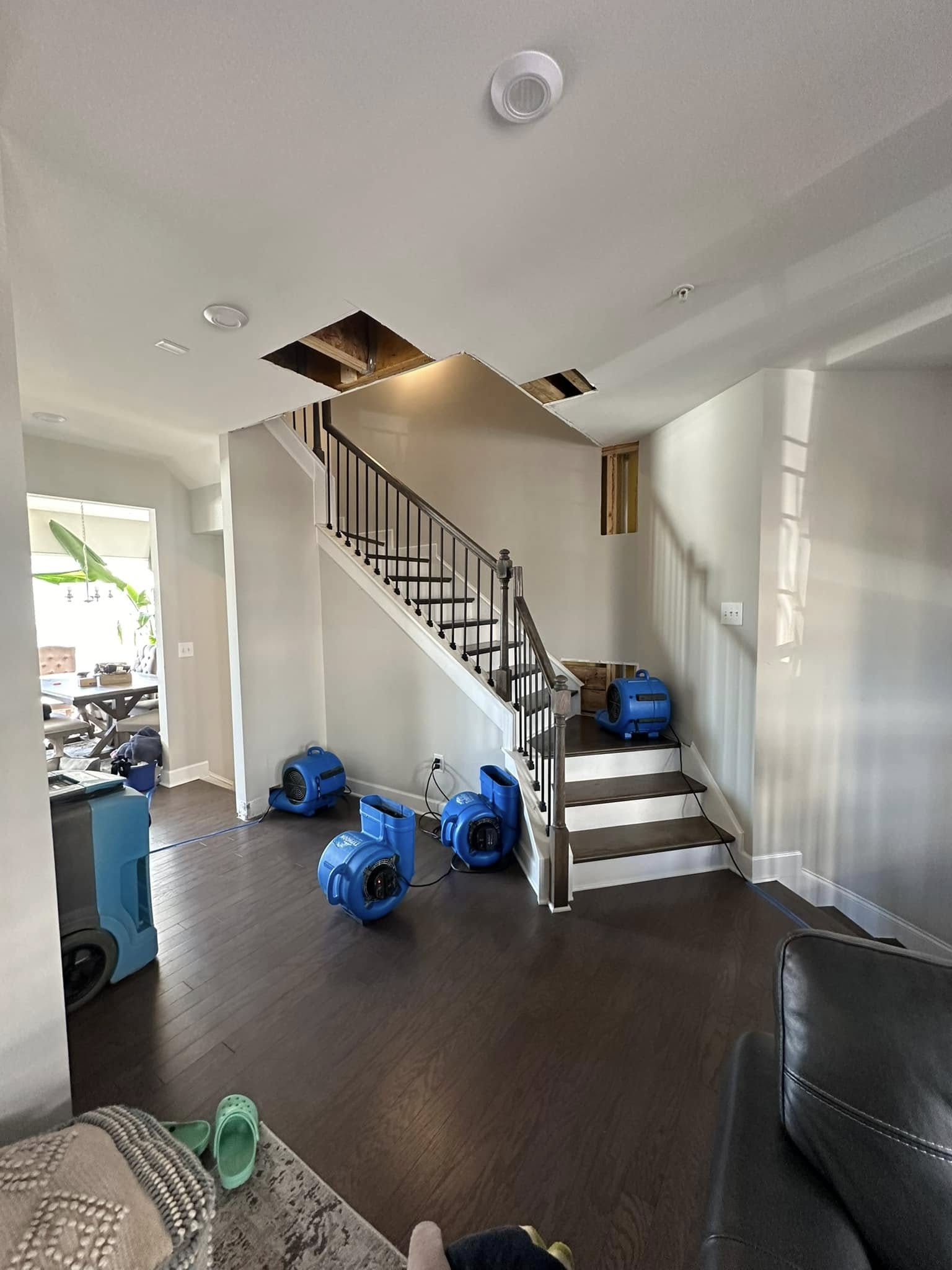 Multiple air movers positioned on stairway during water damage drying by Property Restoration Pros