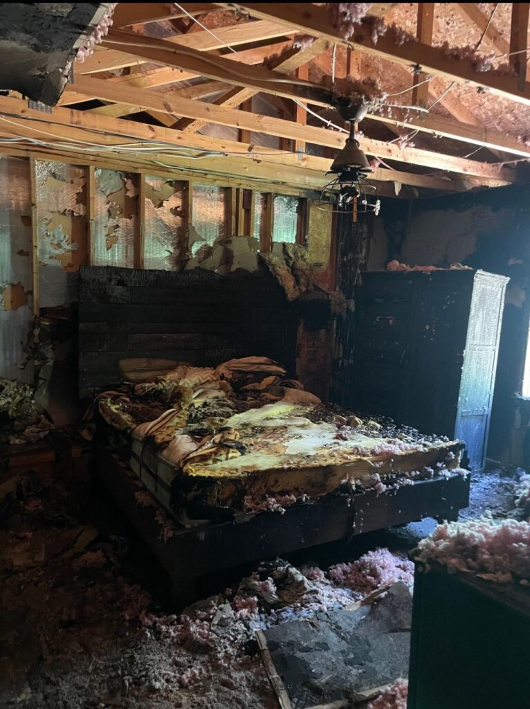 Fire-damaged room with charred structure before restoration by Property Restoration Pros