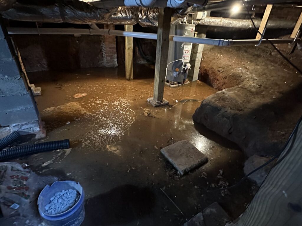 Flooded crawl space with standing water during a water damage emergency handled by Property Restoration Pros